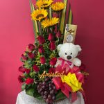 A18 - Canasta con rosas, girasoles, peluche, chocolates y fruta.